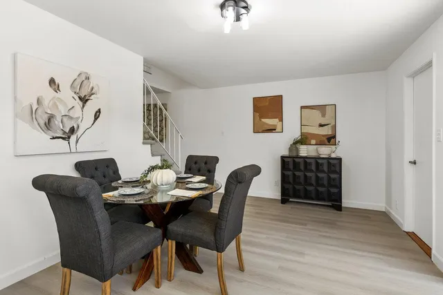 a view of a dining room with furniture and a kitchen