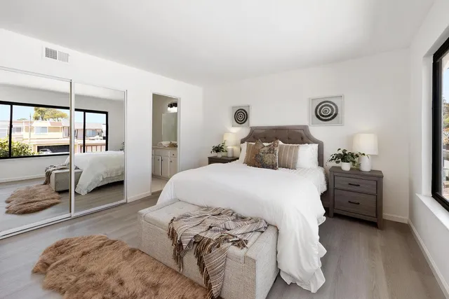 a bedroom with a large window and a bed