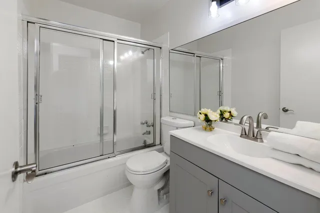 an empty room with sliding door and wooden floor