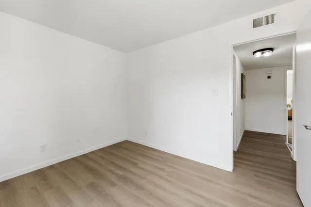 a bathroom with a granite countertop sink a toilet and with mirror