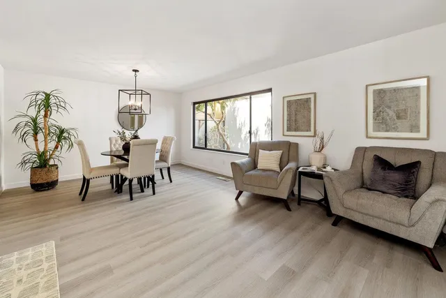 a view of a livingroom with furniture and a floor to ceiling window