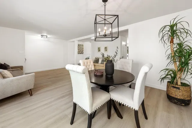 a open kitchen with granite countertop a stove top oven a sink a counter space and cabinets