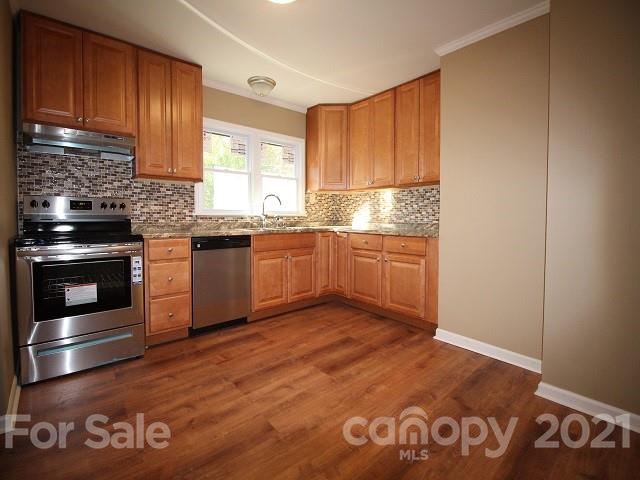166 Cemetery Street Chester, SC 29706 - Photo 11 of 28 a kitchen with granite countertop stainless steel appliances and wooden cabinets