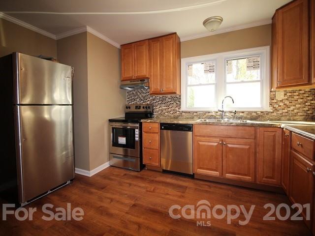 166 Cemetery Street Chester, SC 29706 - Photo 9 of 28 a kitchen with granite countertop stainless steel appliances a refrigerator and a sink