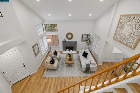 a living room with furniture and a clock