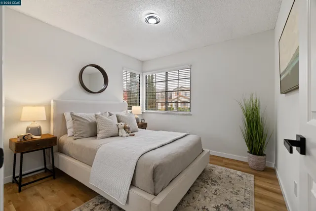 a bedroom with a bed and a potted plant