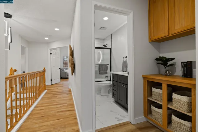 a hallway with white cabinets