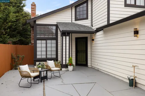 a view of a patio with a table and chairs and couches