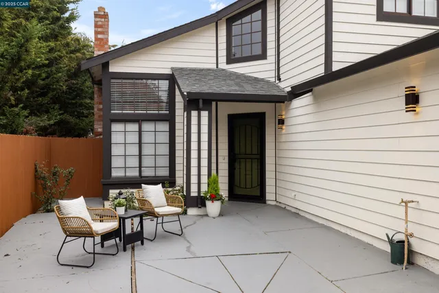 a view of a patio with a table and chairs and couches