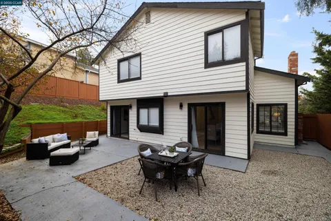 a backyard of a house with outdoor seating