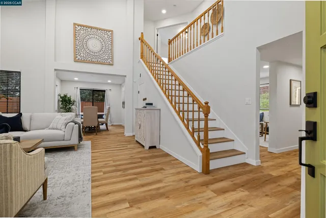 a living room with furniture and stairs