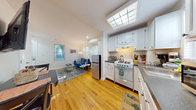 a kitchen with stainless steel appliances granite countertop sink stove top oven and cabinets