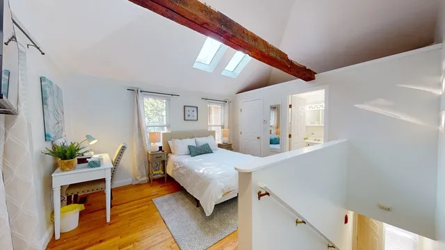 a bedroom with a bed and a potted plant