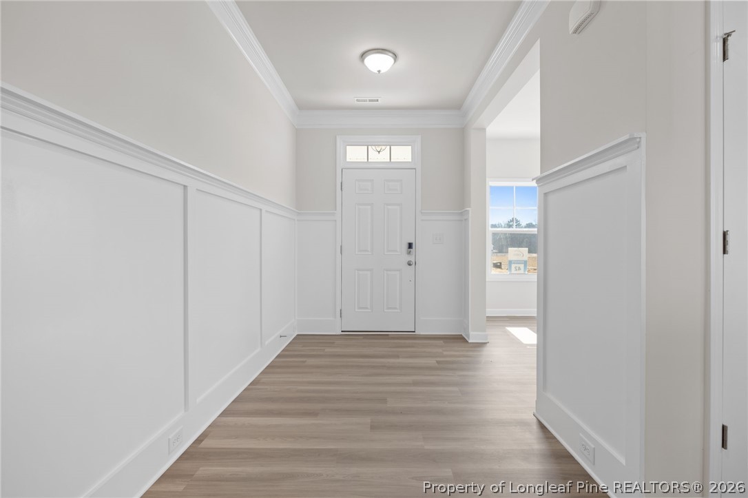 147 Michter Street Vass, NC 28394 - Photo 15 of 48 a view of a hallway with wooden floor
