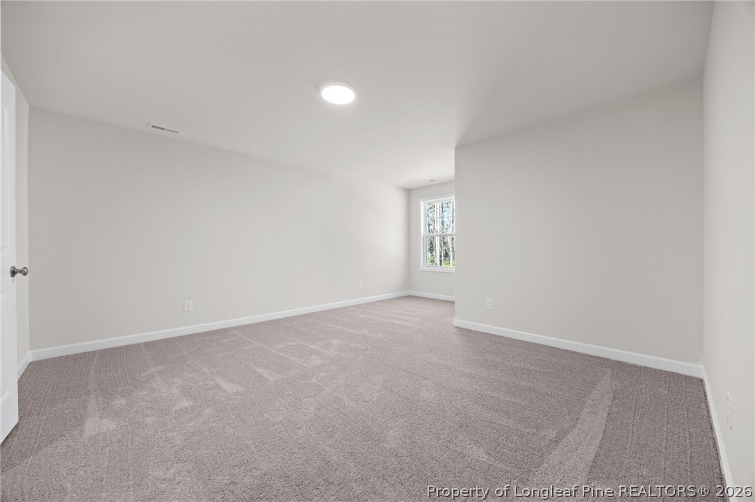 147 Michter Street Vass, NC 28394 - Photo 18 of 48 a view of an empty room with a window