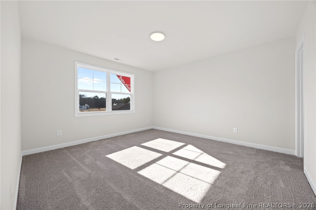 147 Michter Street Vass, NC 28394 - Photo 25 of 48 an empty room with windows and ceiling fan