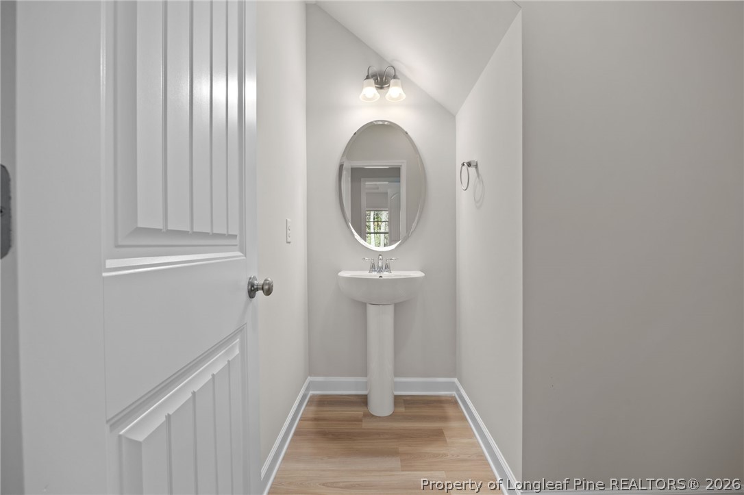 147 Michter Street Vass, NC 28394 - Photo 27 of 48 a view of a hallway with entryway wooden floor and front door