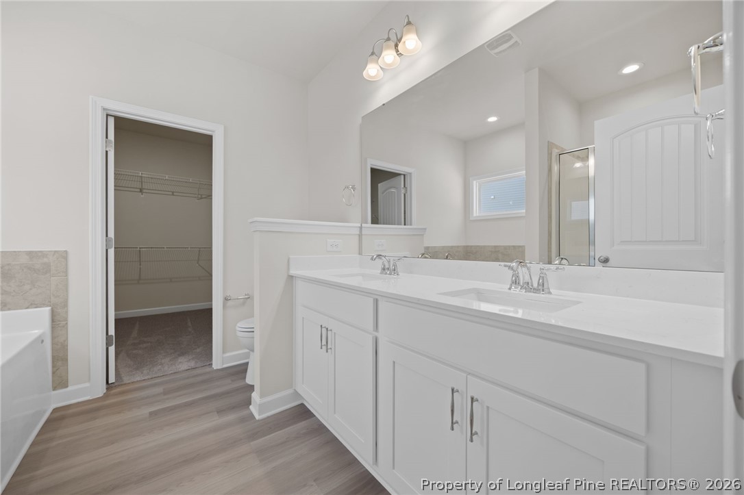 147 Michter Street Vass, NC 28394 - Photo 30 of 48 a bathroom with double vanity sinks and a mirror