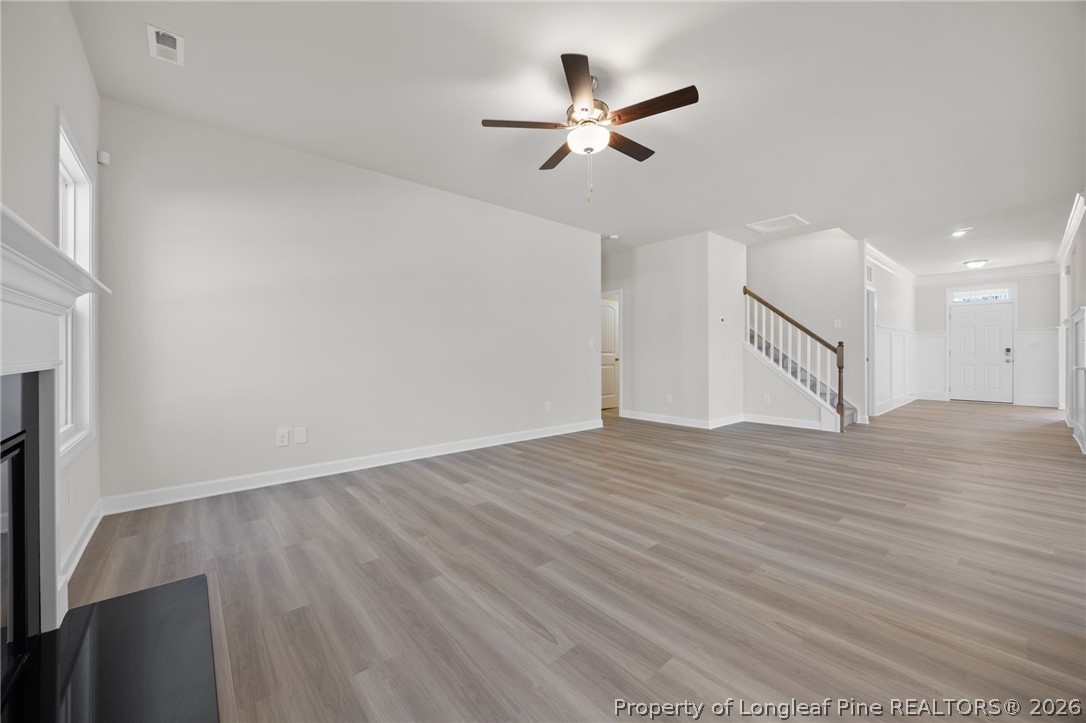 147 Michter Street Vass, NC 28394 - Photo 36 of 48 a view of empty room with wooden floor and ceiling fan