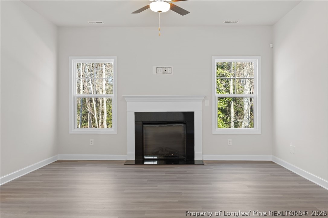 147 Michter Street Vass, NC 28394 - Photo 37 of 48 an empty room with windows and fireplace