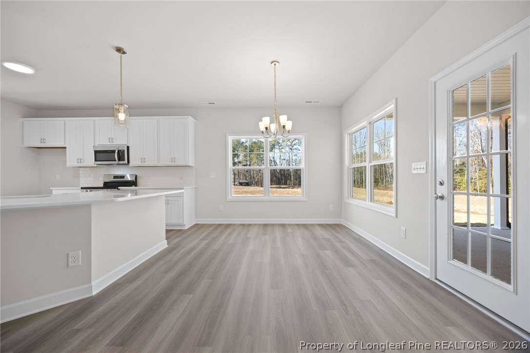 147 Michter Street Vass, NC 28394 - Photo 38 of 48 a kitchen with wooden floors and white walls