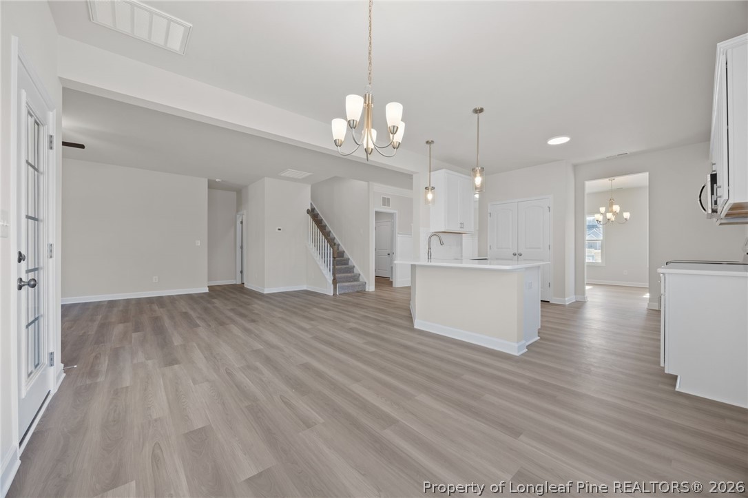 147 Michter Street Vass, NC 28394 - Photo 39 of 48 a view of a kitchen with cabinets and wooden floor