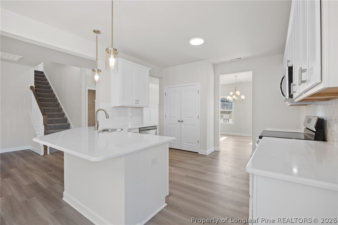 147 Michter Street Vass, NC 28394 - Photo 41 of 48 a large white kitchen with a sink a refrigerator and a stove