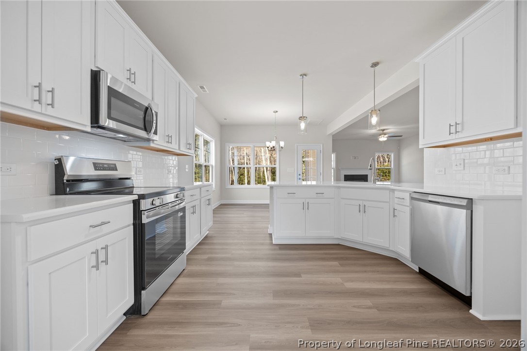 147 Michter Street Vass, NC 28394 - Photo 44 of 48 a large white kitchen with stainless steel appliances