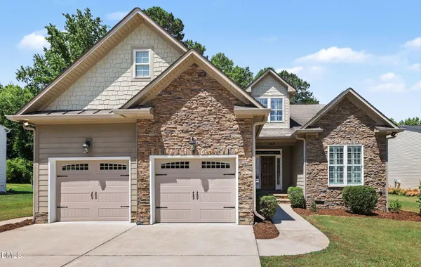 a front view of a house with a yard