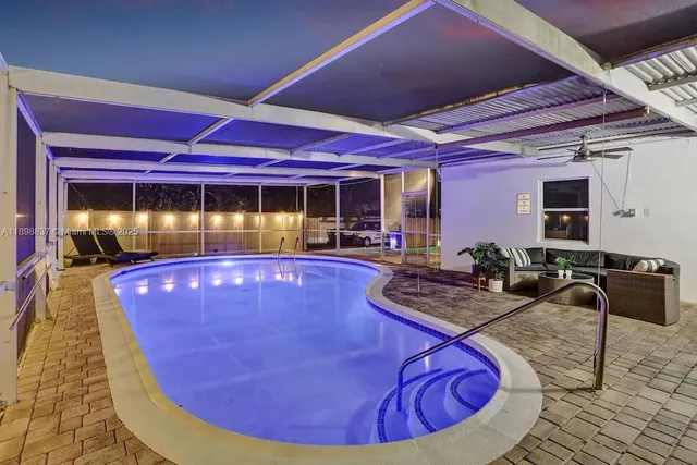 a view of a swimming pool with chairs