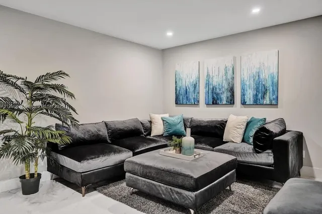 a living room with furniture and a potted plant