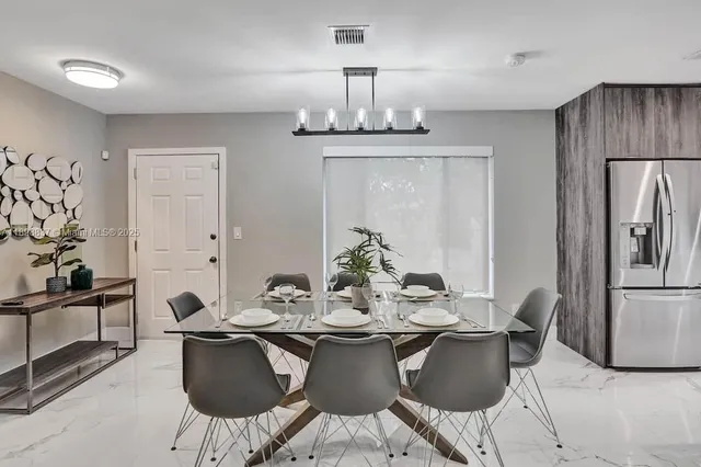 a dining room with furniture and chandelier