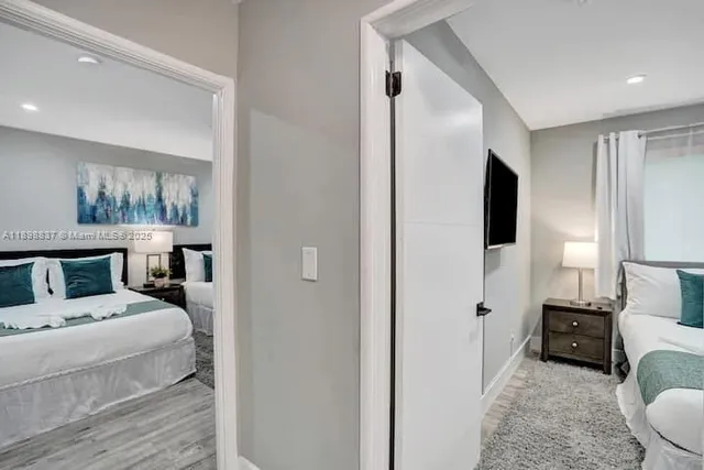 a bedroom with a bed and wooden floor