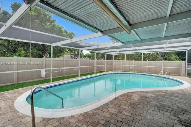 a view of a backyard with swimming pool