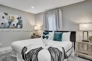 a bed room with a bed and a night stand