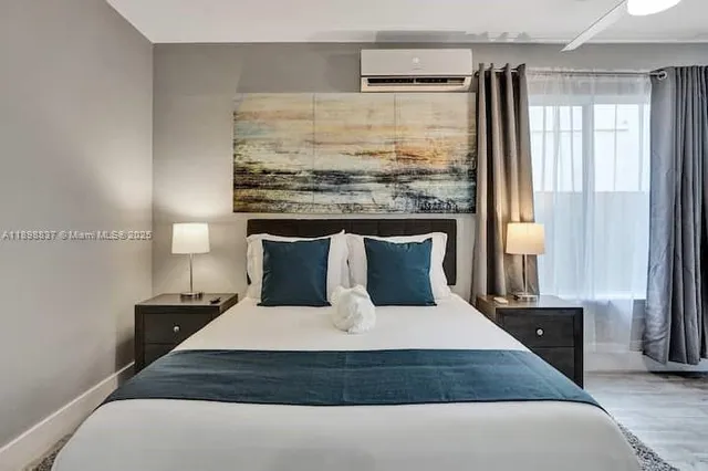 a large bed sitting in a bedroom next to a window