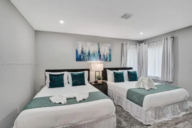 a bedroom with furniture and a large window