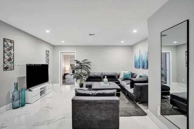 a living room with fireplace furniture and a flat screen tv