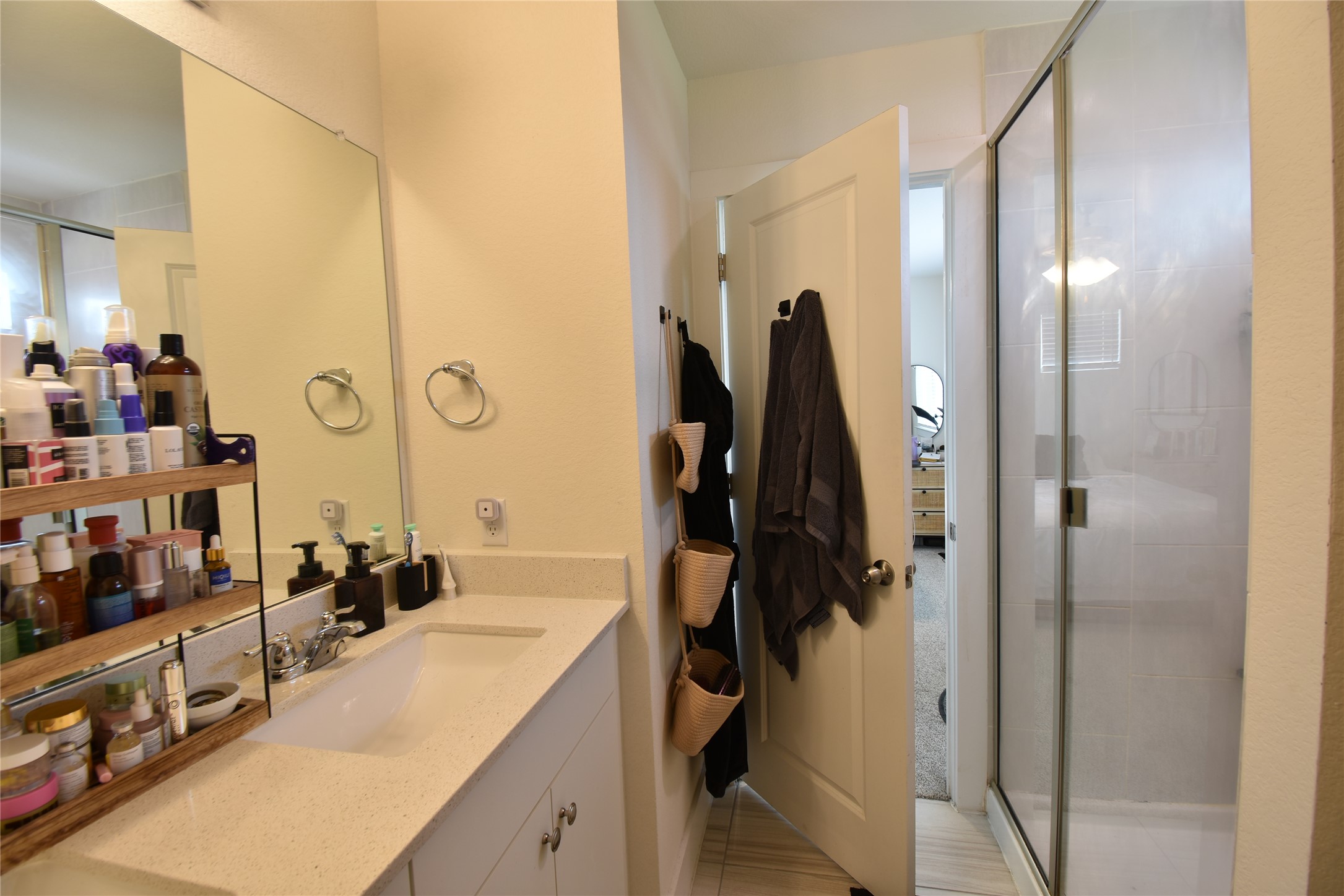331 Alamar Knot Way, Unit 208 Georgetown, TX 78626 - Photo 4 of 17 A well-appointed bathroom features a spacious vanity with an integrated sink and a clear glass-enclosed shower.