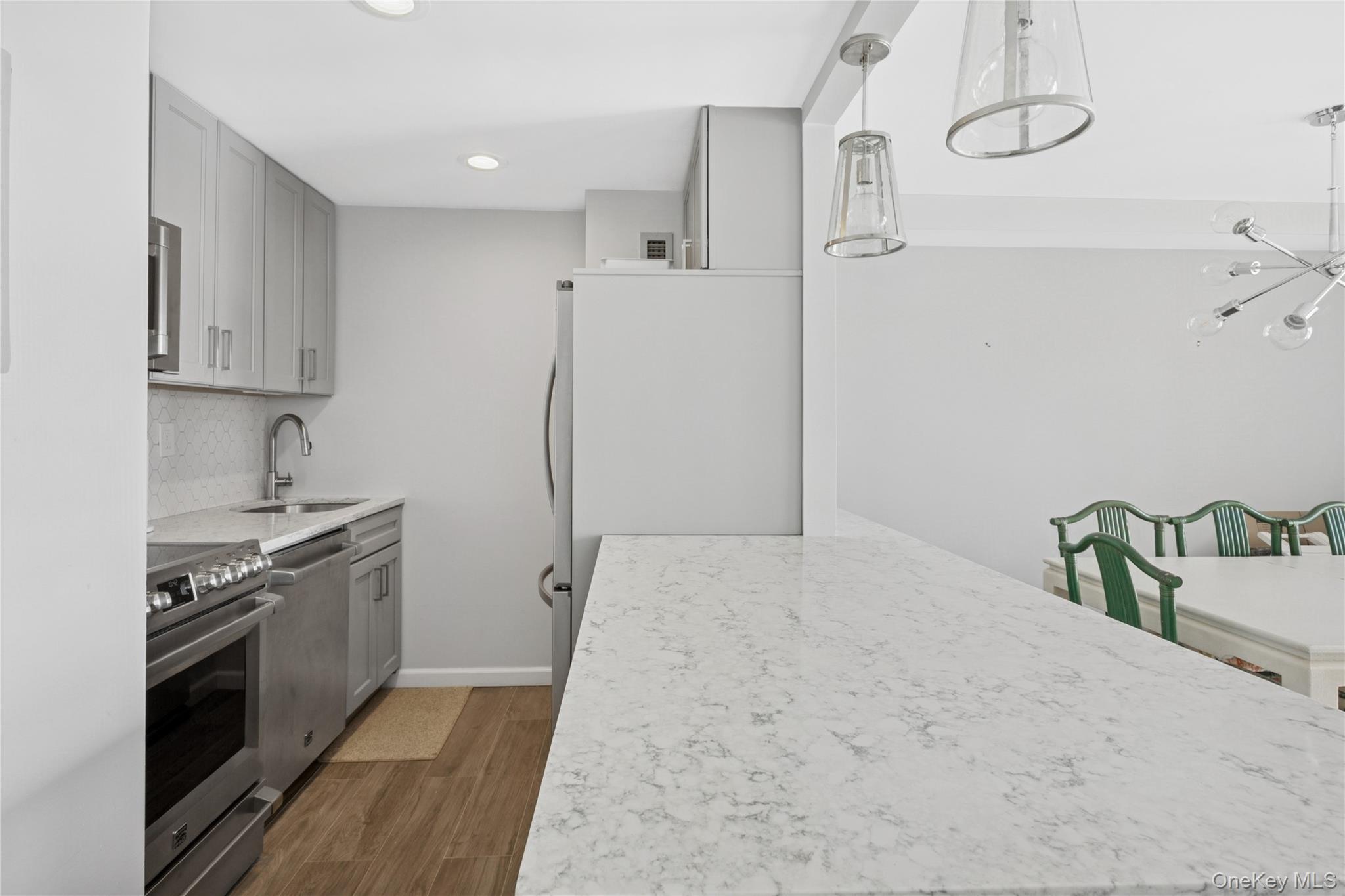2 Richmond Road, Unit 3A Lido Beach, NY 11561 - Photo 12 of 33 a kitchen with stainless steel appliances granite countertop a refrigerator and a stove top oven