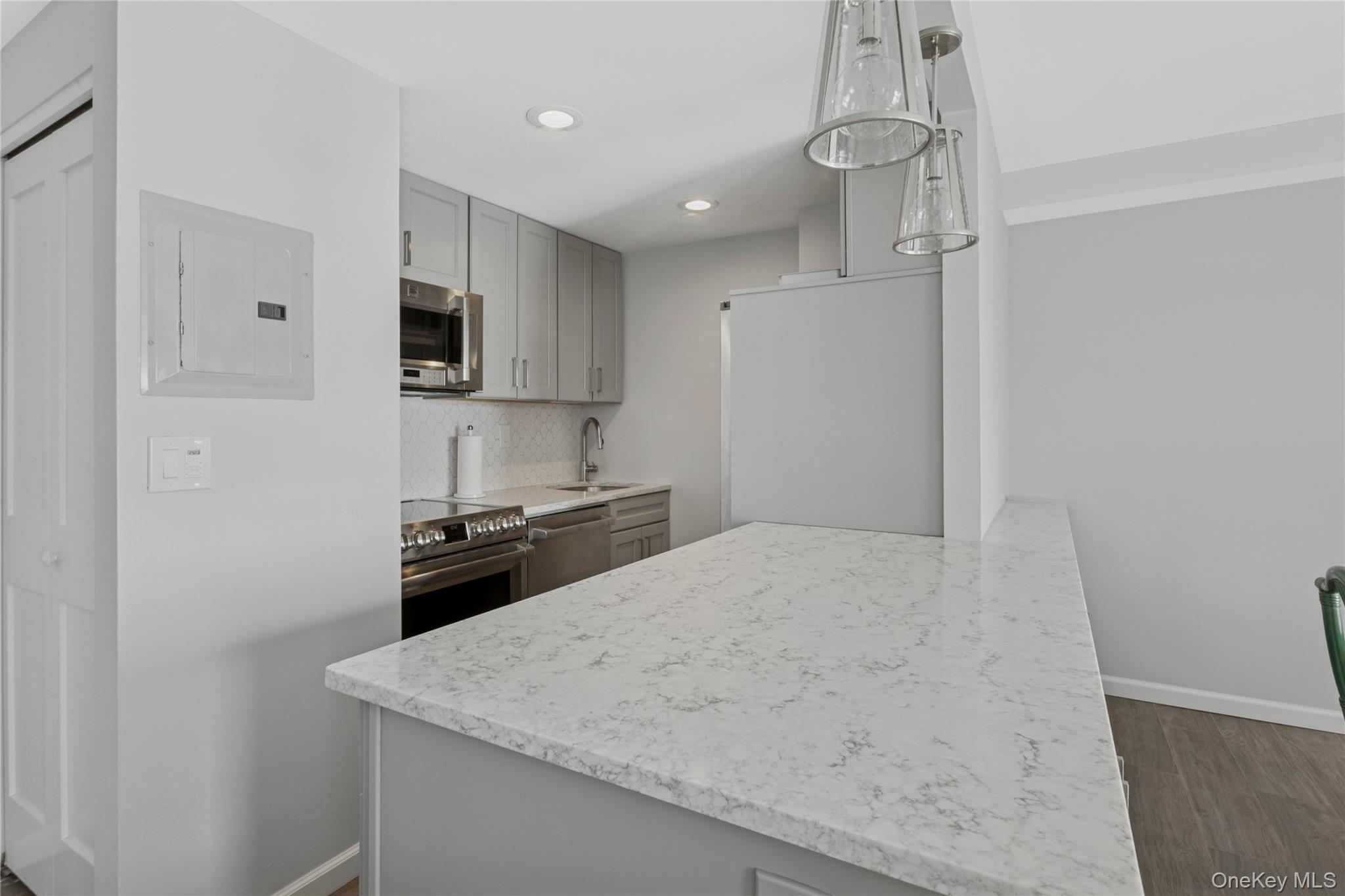 2 Richmond Road, Unit 3A Lido Beach, NY 11561 - Photo 13 of 33 a kitchen with a stove a sink and a refrigerator