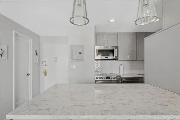 a kitchen with stainless steel appliances a refrigerator and a stove top oven