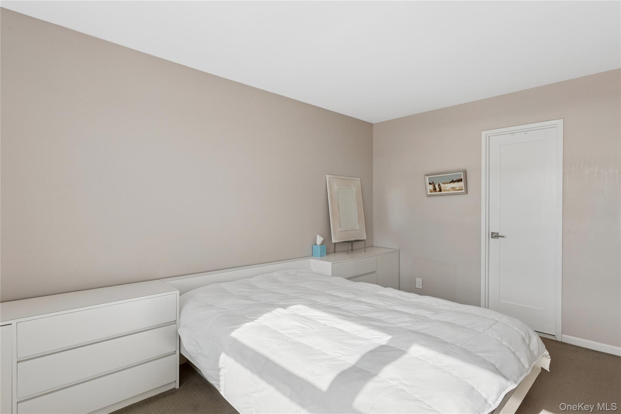 2 Richmond Road, Unit 3A Lido Beach, NY 11561 - Photo 19 of 33 a bedroom with a bed and a cabinets