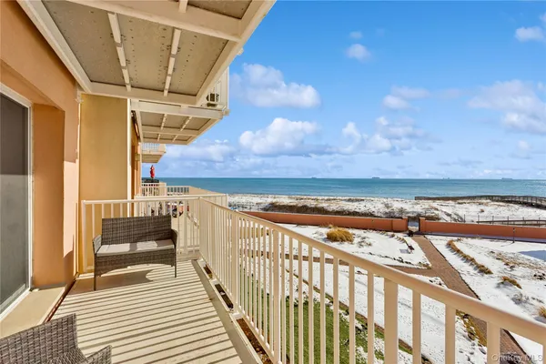 a view of a balcony with an outdoor seating