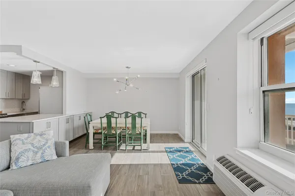 a living room with furniture and two window