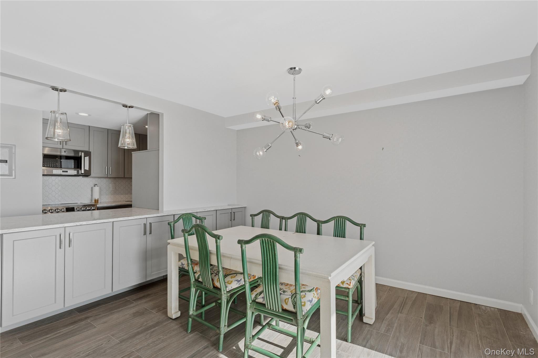 2 Richmond Road, Unit 3A Lido Beach, NY 11561 - Photo 9 of 33 a view of a dining room with furniture and wooden floor
