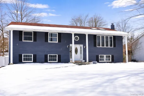 a view of a house with a snow in the yard