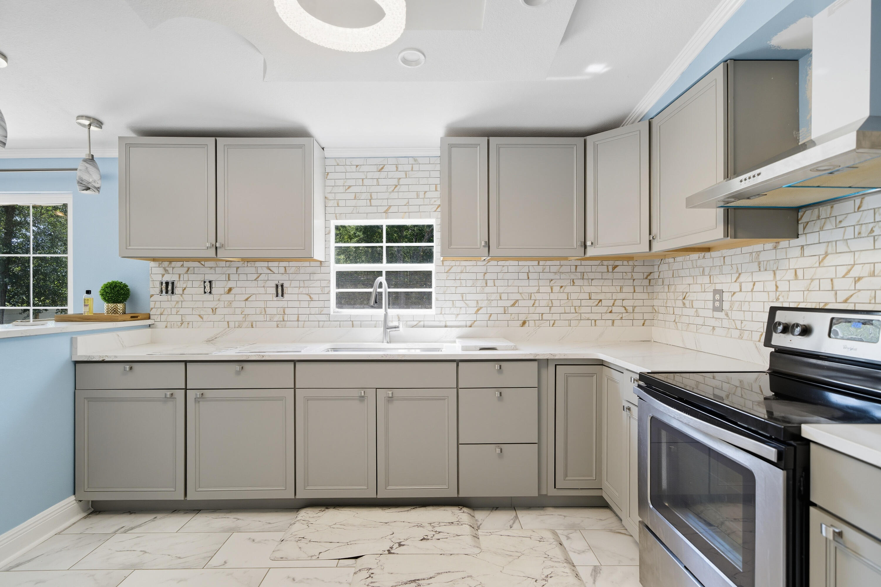 714 East Picasso Road DeFuniak Springs, FL 32433 - Photo 11 of 25 a kitchen with a sink stove and cabinets