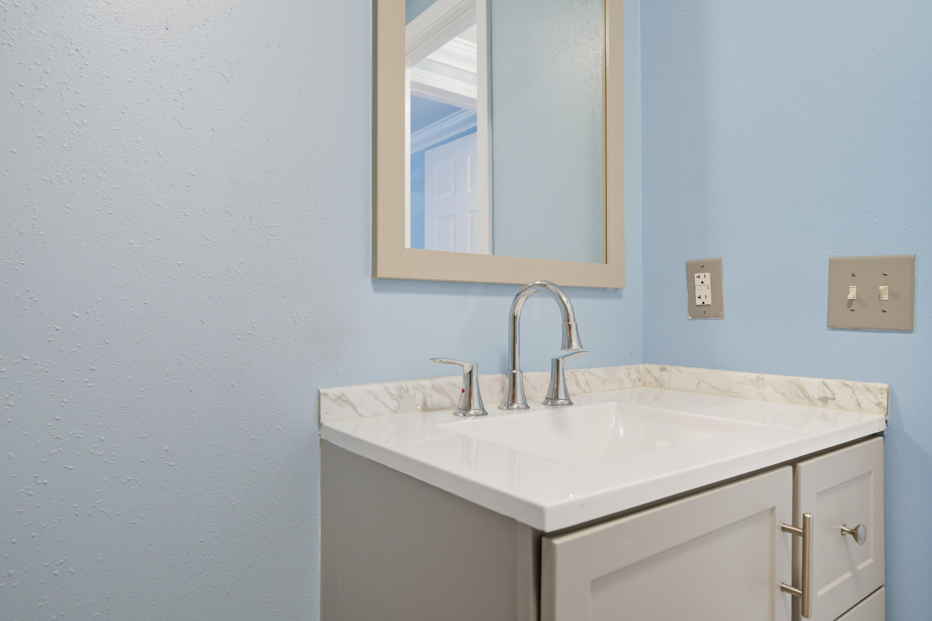 714 East Picasso Road DeFuniak Springs, FL 32433 - Photo 14 of 25 a bathroom with a sink and a mirror