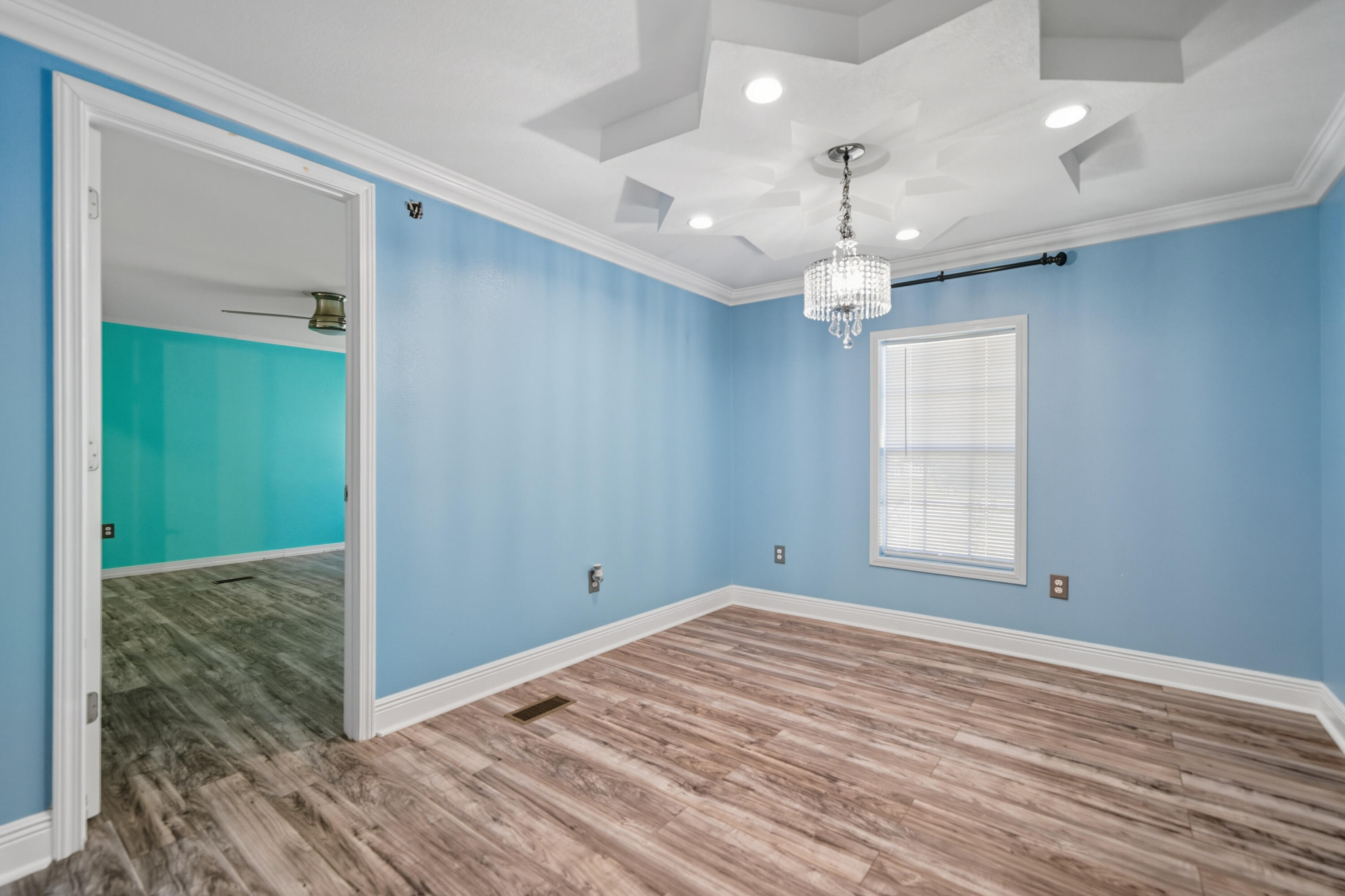 714 East Picasso Road DeFuniak Springs, FL 32433 - Photo 15 of 25 wooden floor in an empty room with a window